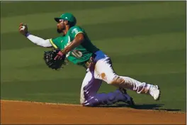  ?? ASHLEY LANDIS — THE ASSOCIATED PRESS ?? A’s shortstop Marcus Semien reaches for an infield single hit by the Astros’ Kyle Tucker during the fourth inning of Game 2 of their American League Division Series in Los Angeles on Tuesday.