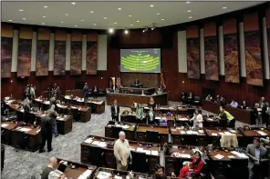  ?? (AP/Matt York) ?? Arizona state representa­tives convene Wednesday on the House floor at the Capitol in Phoenix, Ariz.