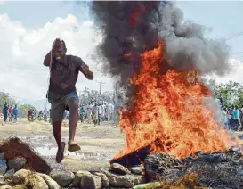  ?? Associated Press ?? National Super Alliance supporters in Kenya’s lakeside city of Kisumu burn tires in streets Wednesday, a day before the country goes to the polls. Police and demonstrat­ors clashed in areas of the city known as an opposition stronghold.