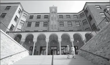  ?? NWA Democrat-Gazette/DAVID GOTTSCHALK ?? Joi Knight (left), director of developmen­t with Haas Hall Academy, and Stacy Keenan, director of developmen­t, walk up the south steps July 25 at the new Haas Hall Academy Rogers Campus in Rogers. The campus is in the former historic Lane Hotel in the...