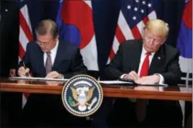  ?? EVAN VUCCI — THE ASSOCIATED PRESS ?? President Donald Trump and South Korean President Moon Jae-In participat­e in a signing ceremony for the United States-Korea Free Trade Agreement at the Lotte New York Palace hotel during the United Nations General Assembly, Monday in New York.