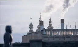  ?? RODRIGO ABD/AP ?? A woman makes her way past a power plant March 16 in Vinnytsia, Ukraine. Officials say Russian hackers tried to knock out power to millions of Ukrainians last week.