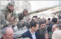  ?? AP PHOTO ?? In this photo released on the official Facebook page of the Syrian Presidency, Syrian President Bashar Assad, centre, speaks with Syrian troops during his visit to the front line in the newly captured areas of eastern Ghouta, near the capital Damascus,...