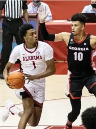  ??  ?? Alabama forward/guard Herbert Jones (1) runs by Georgia forward Toumani Camara (10) during the second half of an NCAA college basketball game on Saturday. (Photo by Vasha Hunt, AP)