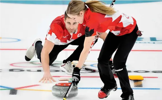  ?? Nathan Denette/The Canadian Press ?? Kaitlyn Lawes and John Morris get down to business in the mixed doubles gold-medal game against Switzerlan­d at the Olympic Winter Games in Gangneung, South Korea, on Tuesday. The Canadian duo dominated, winning 10-3.