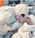  ??  ?? A medical worker tends to a patient at the Casal Palocco hospital near Rome