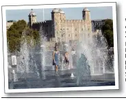  ??  ?? Water jets cool down visitors to Tower of London, left, as beach is packed at Brighton yesterday, right