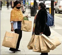  ??  ?? Bagging some bargains...shoppers outside Primark in Birmingham, left, and in Oxford Street, London