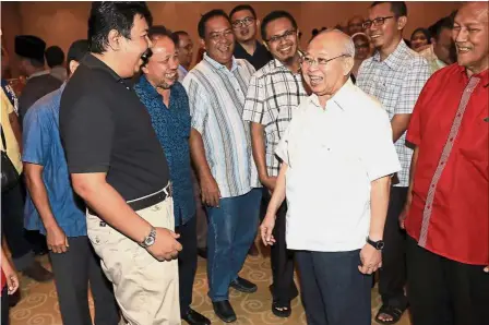  ??  ?? All smiles: Razaleigh sharing a light moment with party members at a meeting in Seremban.