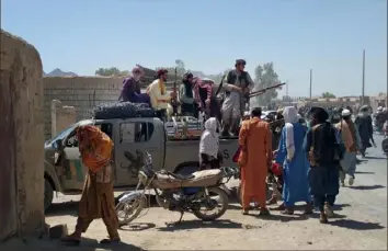  ?? Mohammad Asif Khan/Associated Press ?? Taliban fighters patrol Wednesday inside the city of Farah, capital of Farah province, southwest Afghanista­n. Afghan officials say three more provincial capitals have fallen to the Taliban, putting nine out of the country’s 34 in the insurgents’ hands amid the U.S. withdrawal.