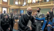  ?? AAron Ontiveroz, The Denver Post ?? Colorado Supreme Court Chief Justice Brian D. Boatright gave a speech Thursday to the House of Representa­tives at the Capitol. Boatright addressed allegation­s of misconduct within the state’s judicial branch. Rep. Kerry Tipper pats Boatright’s shoulder as he passes.