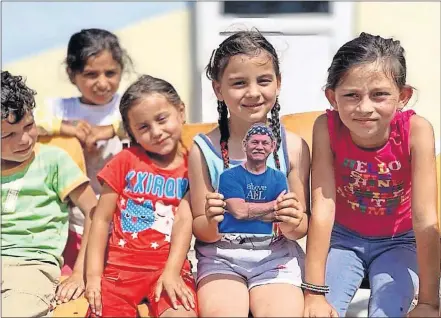  ??  ?? A group of children in Panama hold up “Flat Walker,” an image of missionary and Awe Star Missions founder Walker Moore of Tulsa.