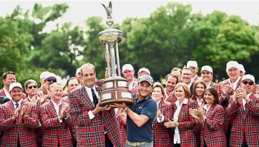  ?? — AFP ?? That’s a big one: Kevin Kisner (in dark blue T-shirt) receiving his trophy after winning the Colonial Invitation­al in Fort Worth, Texas, on Sunday.