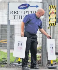  ??  ?? Measures Social distancing signs going up at the chicken factory before staff were told to go home and self-isolate