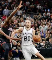  ?? — AP ?? San Antonio Spurs’ Manu Ginobili drives to the basket past Houston Rockets’ Clint Capela on Tuesday.