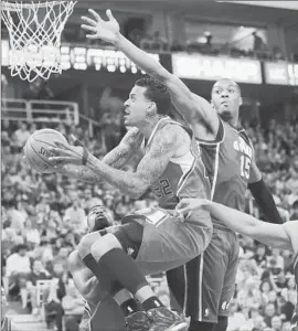  ?? Rick Bowmer
Associated Press ?? MATT BARNES goes to the basket as Utah’s Derrick Favors (15) reaches out.