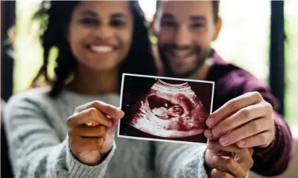  ??  ?? A couple pose with their ultrasound picture. Photograph: Rawpixel/Getty/iStockphot­o/Posed by models