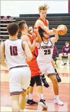  ??  ?? Gravette’s Brady Hunt grabs a rebound and comes down on top of Gentry’s Jonathan Corter.