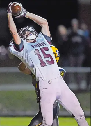  ?? SEAN D. ELLIOT/THE DAY ?? East Lyme’s Dylan Hatajik (15) beats Ledyard’s James Smith (2) for a first quarter touchdown in Friday night’s ECC Division I football game at Mignault Field in Ledyard. East Lyme won 50-14.