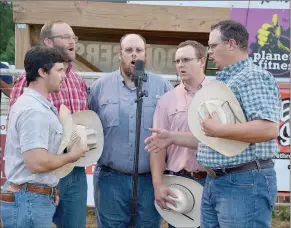  ?? Graham Thomas/Siloam Sunday ?? The Butler Creek Boys, from left, Tanner Andrews, Nick Braschler, Dustin Butler, Austin Butler and Dillon Butler, sing the national anthem Thursday at the Siloam Springs Rodeo.