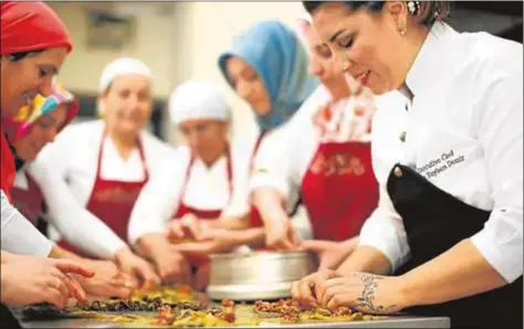  ?? Tansel Baybara ?? Ebru Baybara Demir (derecha) prepara un plato con alumnas de la Escuela de Gastronomí­a