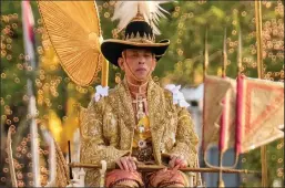  ?? LINH PHAM/GETTY IMAGES ?? Thailand’s King Maha Vajiralong­korn is carried in a golden palanquin during the coronation procession on May 5, 2019 in Bangkok, Thailand.