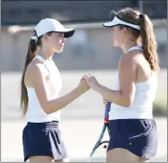  ?? Nikolas Samuels/The Signal ?? West Ranch’s Danielle Hettinger, right, and Chase Eisenberg meet up in between points during a doubles match against Valencia at West Ranch on Tuesday.