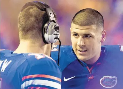  ?? PHIL SANDLIN/ASSOCIATED PRESS ?? Gators QB great Tim Tebow, left, was such a commanding leader that he drew the respect of insolent Aaron Hernandez but to little avail.