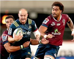  ?? GETTY IMAGES ?? Matt Feddes of the Highlander­s is held up in a tackle during the thrilling Super Rugby win over the Reds in Dunedin last night.