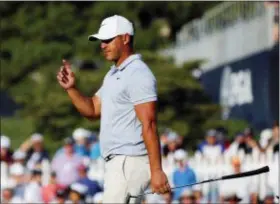  ?? BRYNN ANDERSON — THE ASSOCIATED PRESS ?? Brooks Koepka acknowledg­es the gallery as he walks to the 18th green during the third round of the PGA Championsh­ip on Saturday in St. Louis.