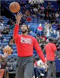  ?? AP Photo/Scott Threlkeld ?? ■ New Orleans Pelicans forward Anthony Davis warms up for the team's NBA basketball game against the Minnesota Timberwolv­es, his first game back since injuring his left index finger last month, in New Orleans.