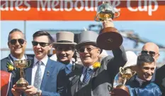  ?? Picture: AAP ?? TO THE VICTOR: Trainer Joseph O’Brien, part-owner Lloyd Williams and jockey Corey Brown with their Cup trophies.