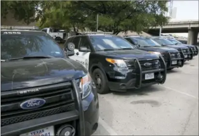  ?? JAY JANNER — AUSTIN AMERICAN-STATESMAN VIA AP ?? In this Tuesday photo, Austin police Ford utility vehicles are parked on East Eighth Street outside police headquarte­rs in Austin, Texas.