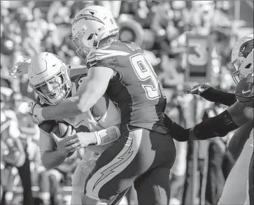  ?? Robert Gauthier Los Angeles Times ?? JOEY BOSA picks up his first sack of the year, taking down Arizona’s Josh Rosen in the second quarter. Bosa added another in the second half. “It felt amazing,” Bosa said of getting his first sack. “It was excitement.”