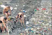  ?? HT PHOTO ?? Workers look for bodies at a drain in Chand Bagh. The four arrested men had allegedly killed four people in separate incidents and dumped the bodies at a different drain in Bhagirathi Vihar.