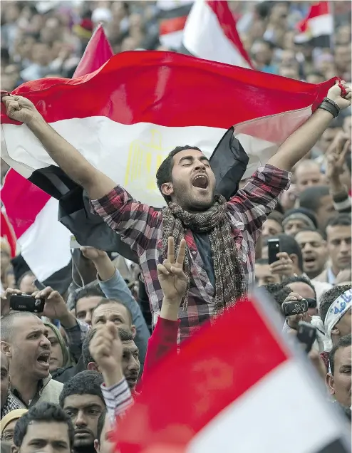  ?? PEDRO UGARTE / AFP / GETTY IMAGES FILES ?? Anti-government demonstrat­ors wave Egyptian flags at Cairo’s Tahrir Square on Feb. 10, 2011.