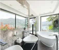  ??  ?? When designing a master bathroom, Nate Berkus suggests incorporat­ing natural elements to add character.