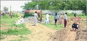  ?? SANJEEV KUMAR/HT ?? Workers constructi­ng a platform after clearing kinnow orchard for Parkash Singh Badal’s cremation at Badal village on Wednesday.