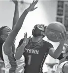  ?? MARK STEWART / JOURNAL SENTINEL ?? Germantown's Kamoria "KK" Arnold goes up for two of her school-record 41 points Friday night.