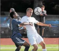  ?? GENE WALSH — DIGITAL FIRST MEDIA ?? Lower Merion’s Thomas Podrasky settles a pass as Plymouth Whitemarsh’s Jacobe Sandcroft defends.