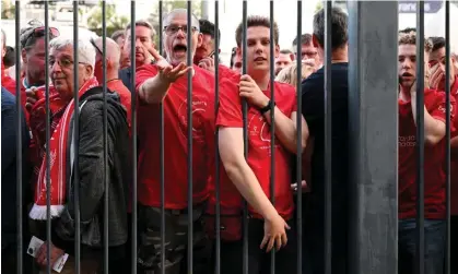  ?? Photograph: Matthias Hangst/Getty Images ?? Liverpool fans wait outside the Stade de France before the Champions League final against Real Madrid in May.