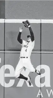  ??  ?? Astros center fielder George Springer made a catch against the wall in center field to hold off a dangerous rally from the Yankees in Game 6 of the ALCS.