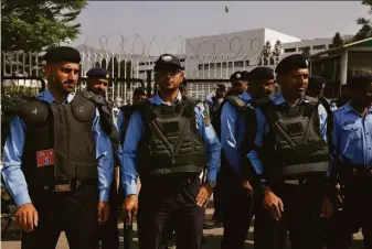  ?? Anjum Naveed / Associated Press ?? Police officers assemble outside the National Assembly in Islamabad, the capital of Pakistan, to ensure security. Embattled Prime Minister Imran Khan has called for national protests Sunday.