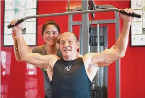  ??  ?? Corina admires her father Tan Khoon Beng, 77, who exercises regularly at the gym. — Photos: ALFRED LAI