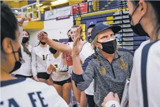  ??  ?? Santa Fe High volleyball coach Josie Adams encourages her team during a timeout against Cleveland in the semifinals of the Class 5A State Volleyball Tournament. The Demons won in straight sets. ‘This team, it’s a family that takes care of each other,’ Adams said after the match. ‘They’re workers and they listen to each other and the coaches. There’s no drama.’