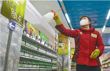  ?? AP ?? A clerk disinfects inside a department store in Pyongyang yesterday, amid growing concern in North Korea over the coronaviru­s outbreak. North Korean leader Kim Jong Un has said there will be ‘‘serious consequenc­es’’ if the illness spreads to the reclusive country.