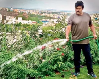  ??  ?? Chiranjeev­i watering the plants in his house