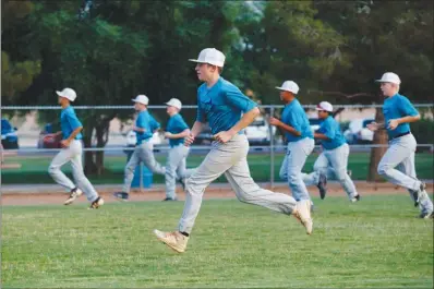  ?? WADE VANDERVORT ?? Silverado All Stars player Jake Glaser warms up with his teammates Wednesday during practice at Silverado Ranch Park. Silverado is heading to regionals this weekend in California with a chance to qualify for the Little League World Series.