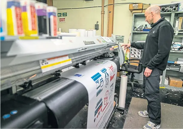  ?? ?? NEW START: Graphic designer Alan Donald on the large format printer at Levenmouth Printers where new owners hope to build the business.