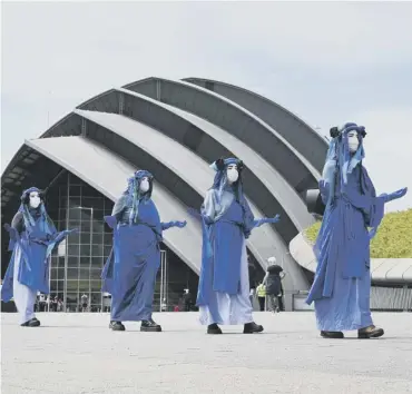  ??  ?? 0 Extinction Rebellion Scotland dress up and perform to highlight sea level rise.